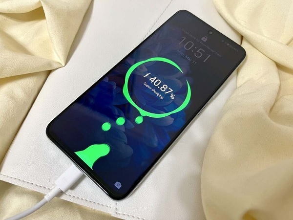 A cellphone charging on a blanket
Description automatically generated