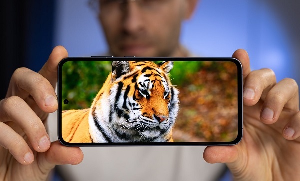 A cell phone on a white surface

Description automatically generated