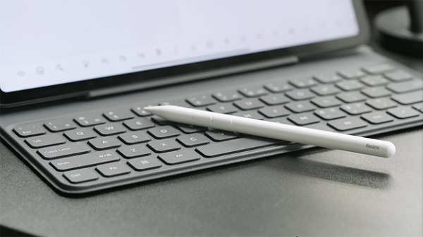 A pen on a keyboard
Description automatically generated