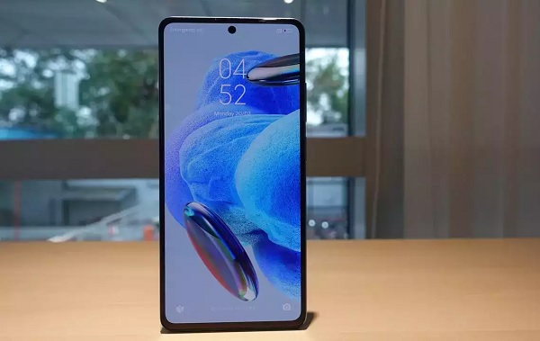 A cell phone on a red surface
Description automatically generated