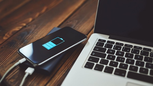 A cell phone on a computer
Description automatically generated