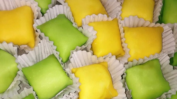 A group of colorful square shaped food

Description automatically generated