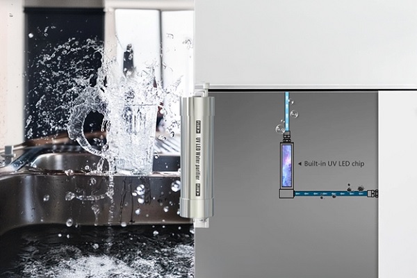 A close-up of a water splashing on a refrigerator

Description automatically generated