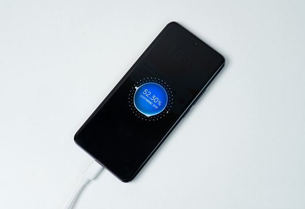 A cell phone on a stone surface
Description automatically generated