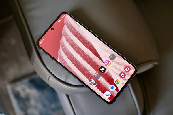 A cell phone on a arm rest

Description automatically generated