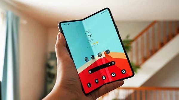A person holding a foldable phone
Description automatically generated