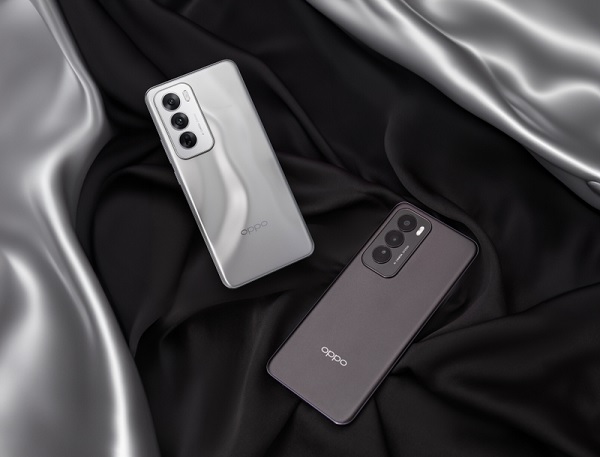 A group of cell phones on a black and silver fabric

Description automatically generated