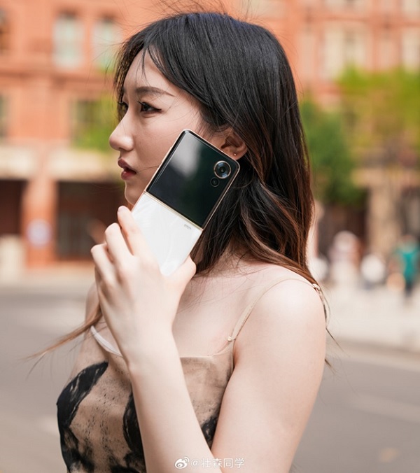 A person holding a cell phone to her ear
Description automatically generated