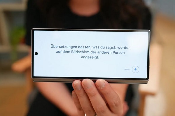 A person holding a rectangular device
Description automatically generated