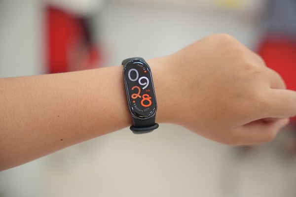 A smart watch with a green strap
Description automatically generated