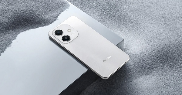 A white cell phone on a silver surface
Description automatically generated