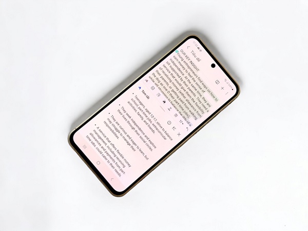 A cell phone with text on screen
Description automatically generated