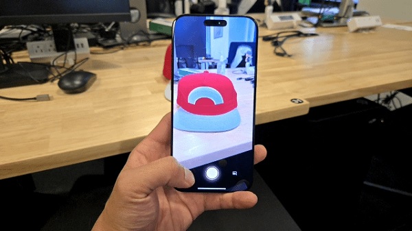 A hand holding a phone with a dog on it

Description automatically generated