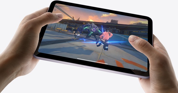 A hand holding a tablet with a video game screen
Description automatically generated