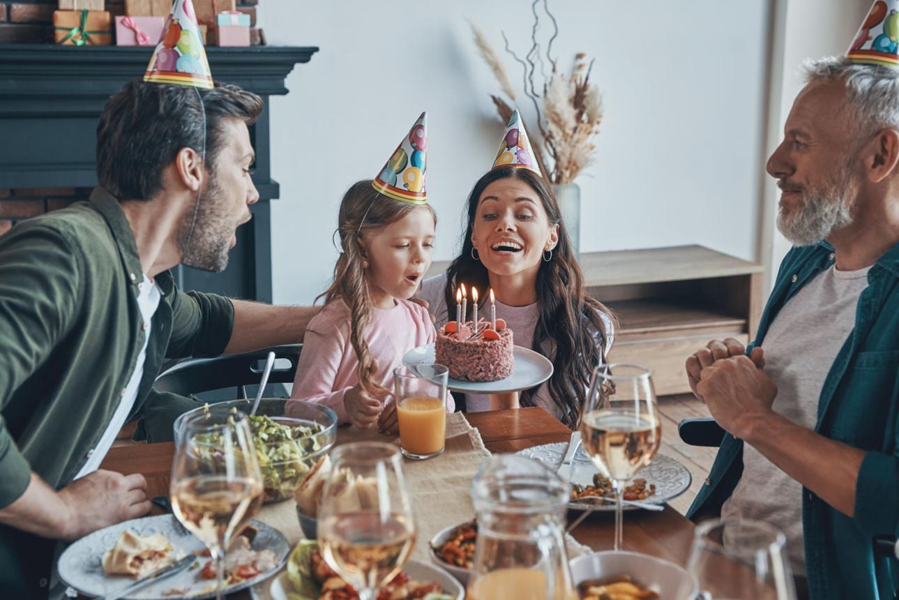 Happy family celebrating birthday of little girl